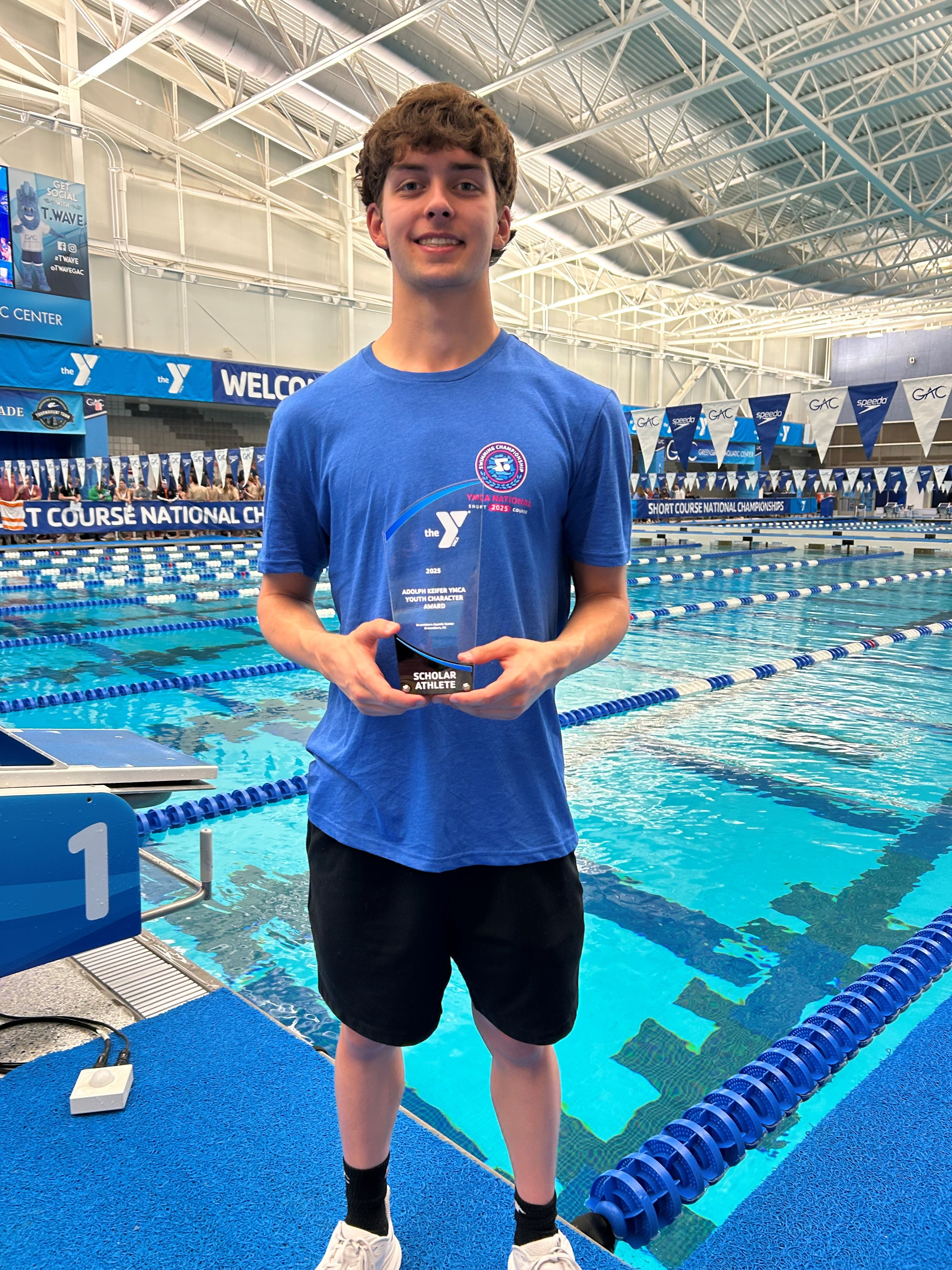 Nolan McCloskey poses with his award