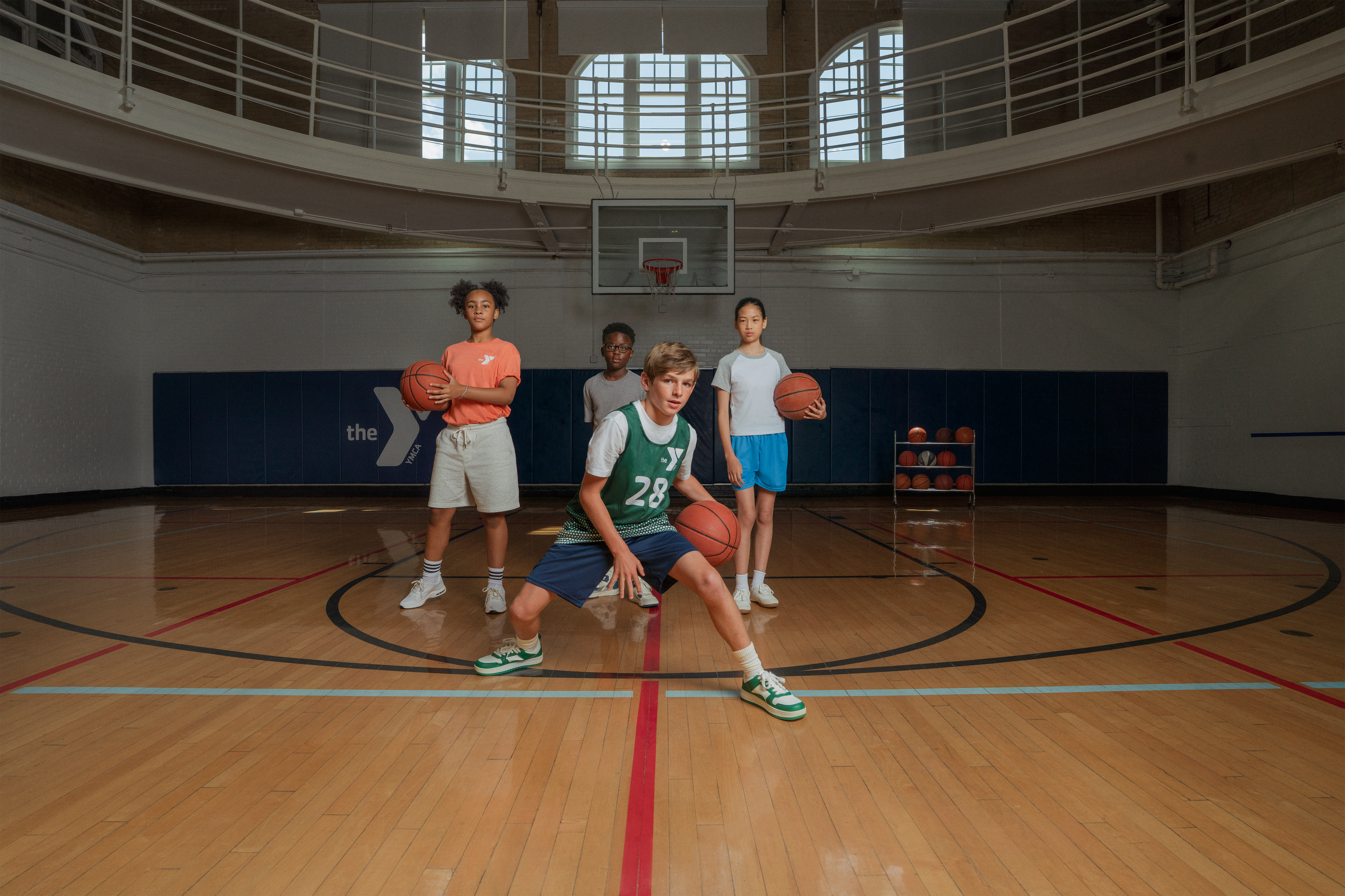 Youth playing basketball on a court